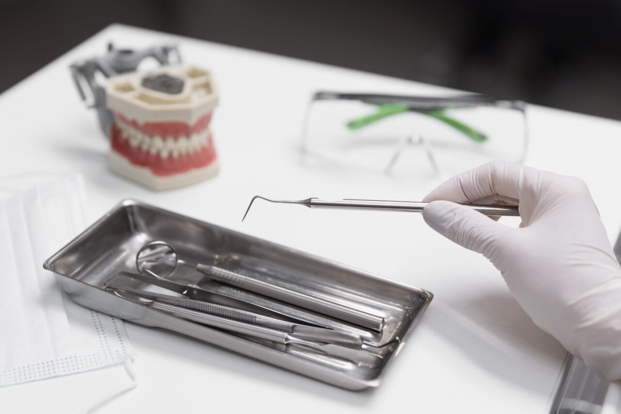 close-up-hand-holding-dental-equipment